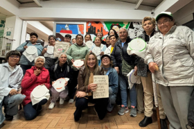 Estudiantes de Utadeo posan junto a un grupo de adultas mayores con quienes comparten en un taller de tejido